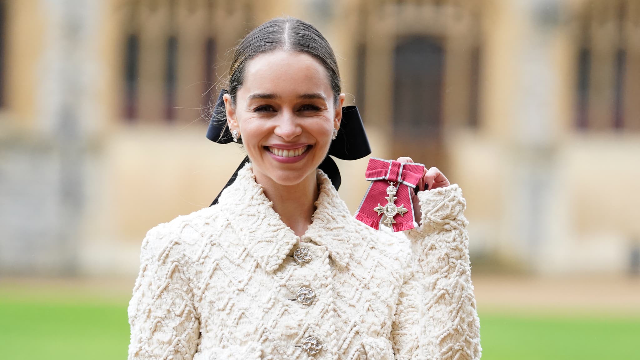 Dressed in Chanel, actress Emilia Clarke was honored by Prince William at Windsor Castle